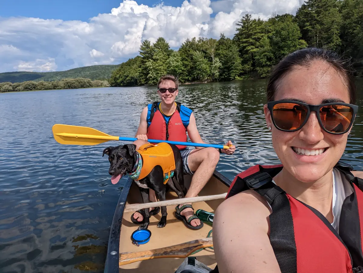 Danielle, Quentin and Gracie in a canoe on a bright sunny day.