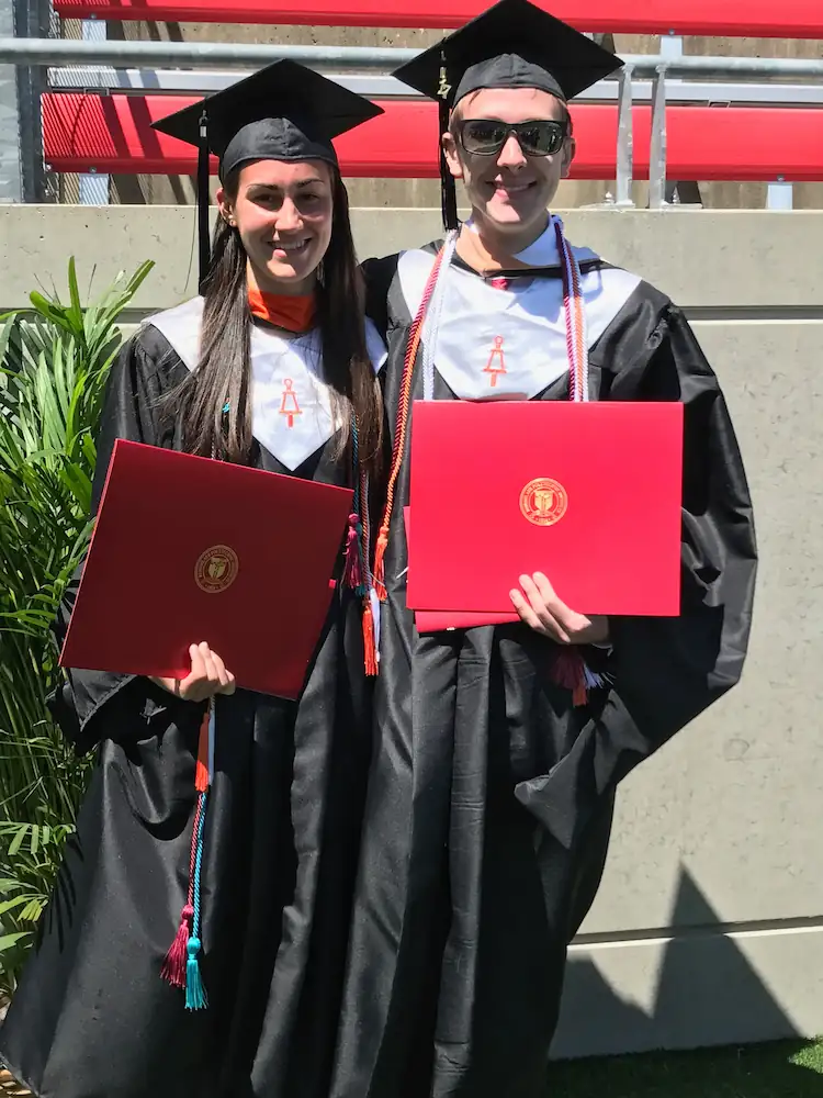 Danielle and Quentin graduating from RPI, holding their diplomas.