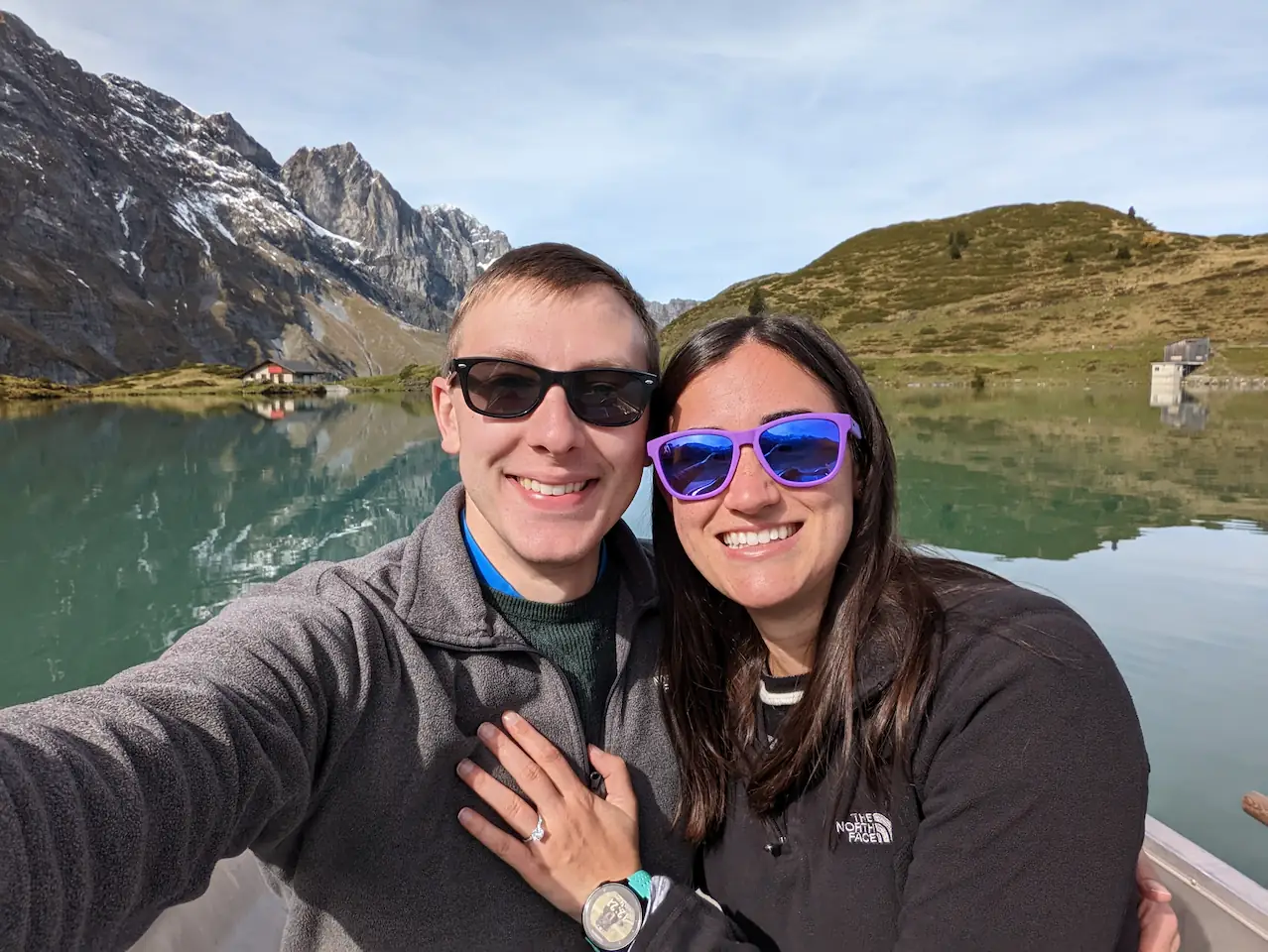 Danielle and Quentin in the rowboat, Danielle with a ring on her finger and her hand on Quentin's chest.