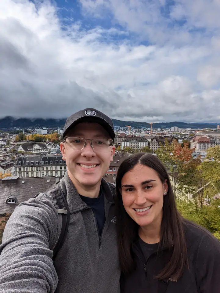 Danielle and Quentin standing in front of a lookout point above the city of Zurich, Switzerland.